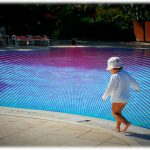 Child next to a swimming pool
